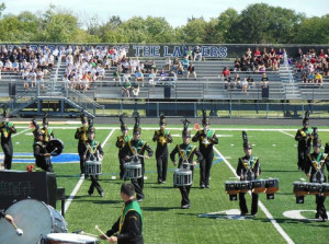 Photo courtesy of Tolguy Ture. Percussionists display athleticism and coordination during a competition. The marching Grenadiers compete against schools from all over the state. While marching band is a fine art, it also involves physical aspects as well. Band members need strength, coordination and precision while performing in competitions.