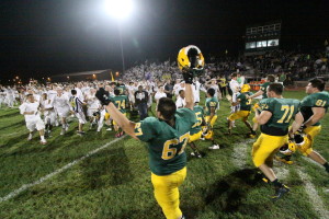 Photo by Joe Gonzalez. Senior Austin Sautter raises his arms as Gren fans stormed the field after their 34-33 win over Rolling Meadows on Oct. 4.