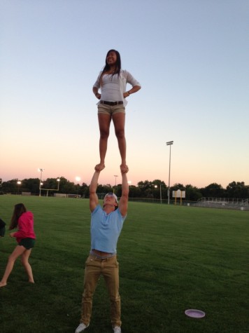 photo by Tiffany Heffy. 
Junior Daniel Larucci holds junior Jennifer Tan up in a one-man stunt. Partner stunting is Larucci’s favorite part of cheerleading.