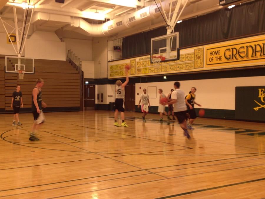 photo by Ryan Herrera.  Since try-outs were so recent, the boys basketball team uses every second of practice to prepare for the upcoming tournament.