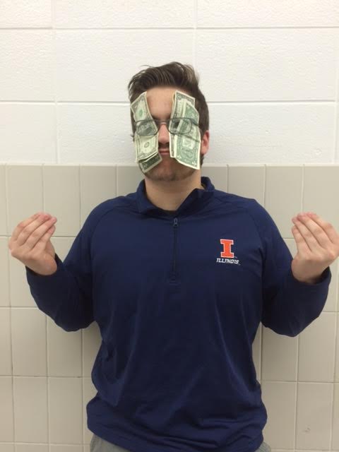 THE PRICE OF SPORTS: Senior Michael Parisi poses to exaggerate the expense athletes must invest in their sport.