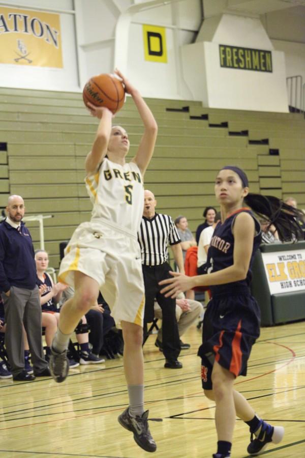 JUMP START: Senior Abbey Sloan shoots past St. Viator’s defender in the varsity team’s December 8 game that they ultimately lost. Despite the limited success the team has experienced in terms of wins, the team has a strong sense of community and plays the game at a very fast pace.