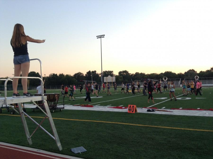 MARCHING GRENS PRACTICE: Senior and drum major Kathryn Riopel conducts the Marching Grens before competition.