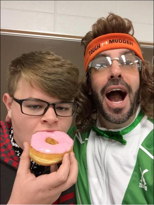 THE BIG REVEAL: Mr. PBIS eating donuts with sophmore Liam McCarthy while showing off costume change to classes