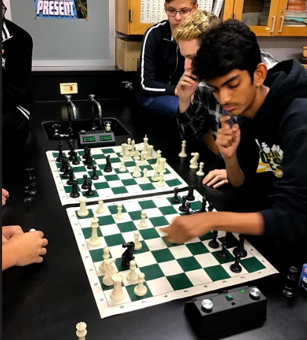Senior Kunal Patel focuses on his next move during a chess practice. 
