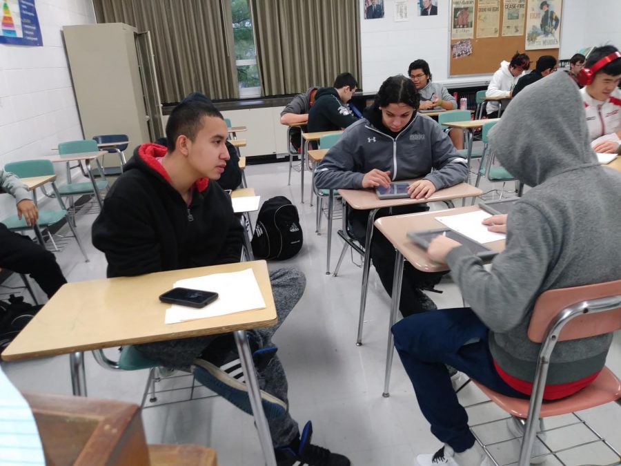 Sophomores Carlos Cedillo (left) and Caden Dixon (middle) discuss the health effects of vaping during their 1st period sophomore pilot class.