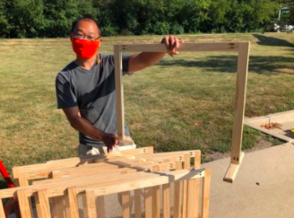 Keith Mukai, pictured here with one of his desk shields, made the shields for Elk Grove teachers for when they return in close proximity to students.