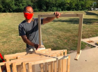 Keith Mukai, pictured here with one of his desk shields, made the shields for Elk Grove teachers for when they return in close proximity to students. 