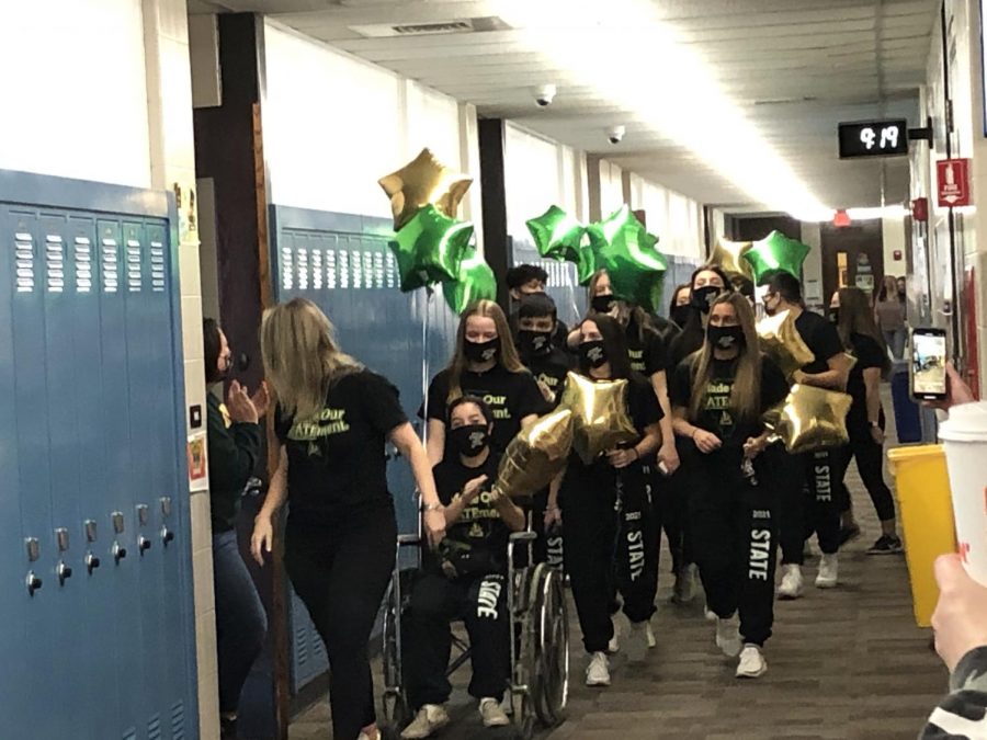 The Elk Grove High School co-ed cheerleading team marches down the English hallway during the team's state send-off. Photo by adviser Kevin Modelski