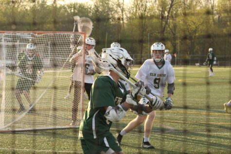 Nick Eizenga, in white, anticipates his opponents pass during a lacrosse game in April.
