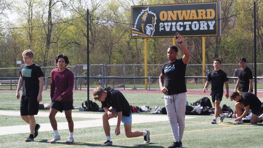 Head+boys+track+coach+Miles+Osei+raises+a+hand+during+a+practice+in+April.+Osei+is+leaving+Elk+Grove+to+be+the+head+football+coach+at+Kankakee+High+School.