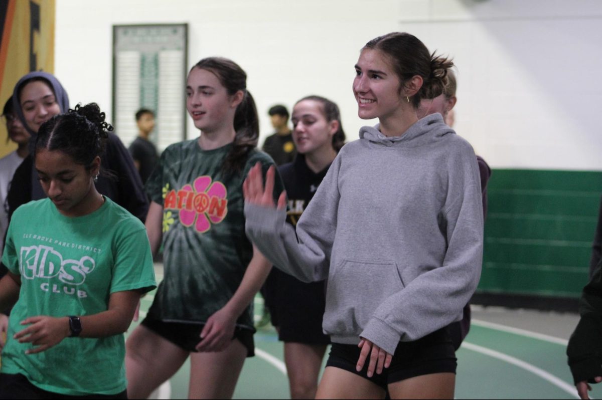 Delaney Malone waves during an indoor running practice at Elk Grove High School